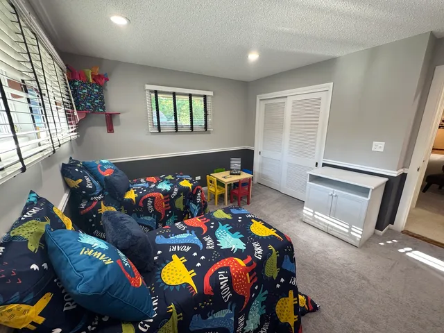 a living room with furniture and a floor to ceiling window