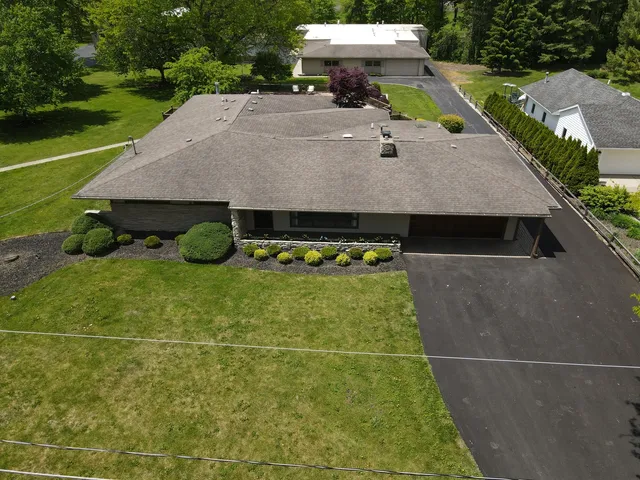 a view of a swimming pool with a yard and plants
