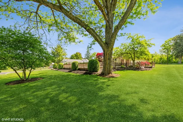 a view of a house with a yard and garden