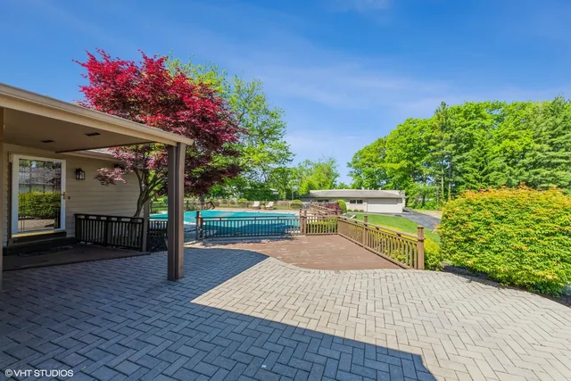 a view of a porch with wooden floor and fence