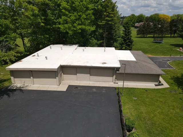 a view of house with backyard and outdoor seating