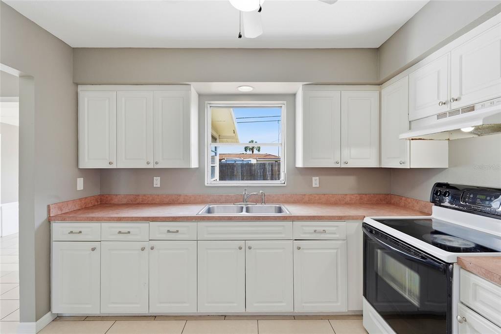 363 Glen Oak Road Venice, FL 34293 - Photo 20 of 53 a kitchen with white cabinets and white appliances