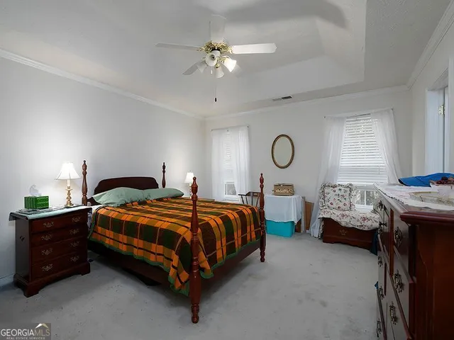 a bedroom with bed and window