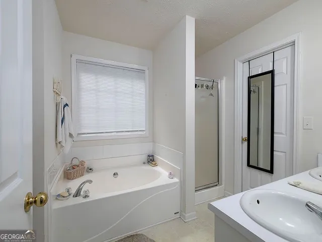 a bathroom with a tub and a sink