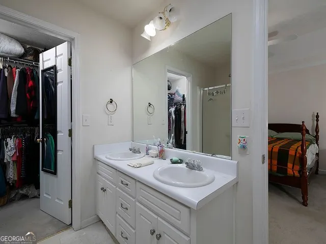 a bathroom with a sink double vanity and a mirror