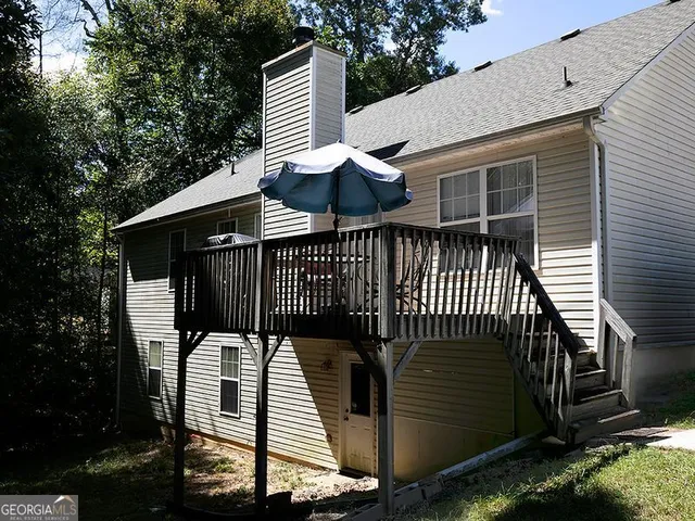a view of a roof deck with wooden floor and fence