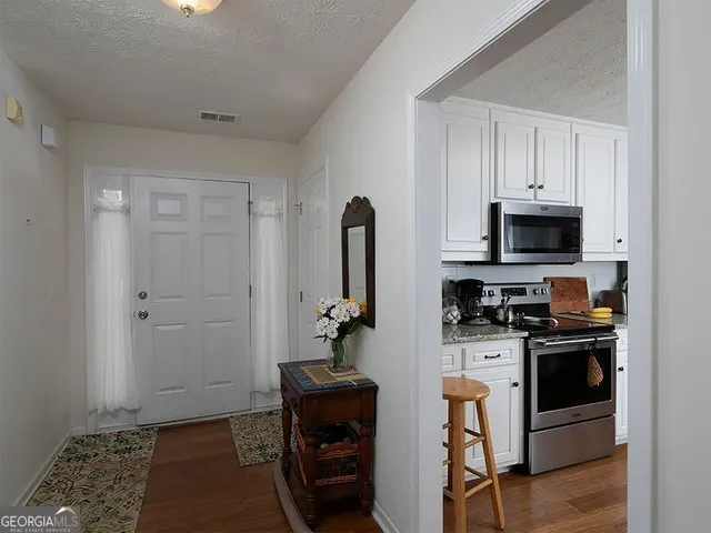 a kitchen with stainless steel appliances granite countertop a stove and a refrigerator