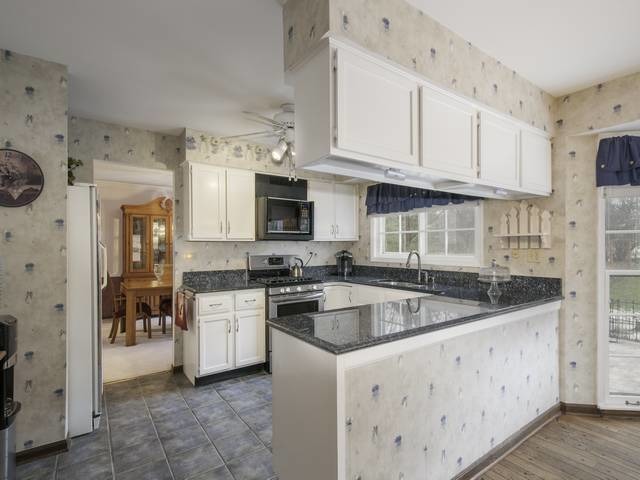 2N555 Beith Road Elburn, IL 60119 - Photo 11 of 22 a kitchen with granite countertop a sink and white cabinets