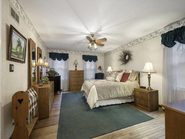 2N555 Beith Road Elburn, IL 60119 - Photo 18 of 22 a spacious bedroom with a bed a couch and a chandelier