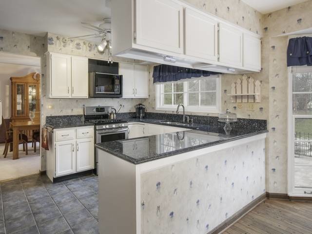 2N555 Beith Road Elburn, IL 60119 - Photo 10 of 22 a kitchen with granite countertop a sink stove and cabinets