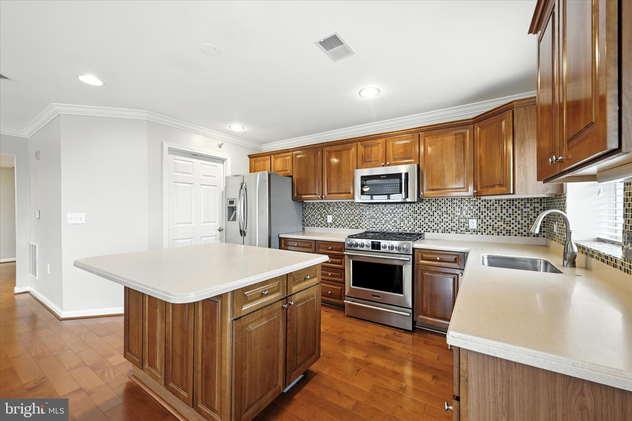 12240 Roundwood Road, Unit 808 Lutherville-Timonium, MD 21093 - Photo 13 of 31 a kitchen with stainless steel appliances granite countertop a sink stove and refrigerator