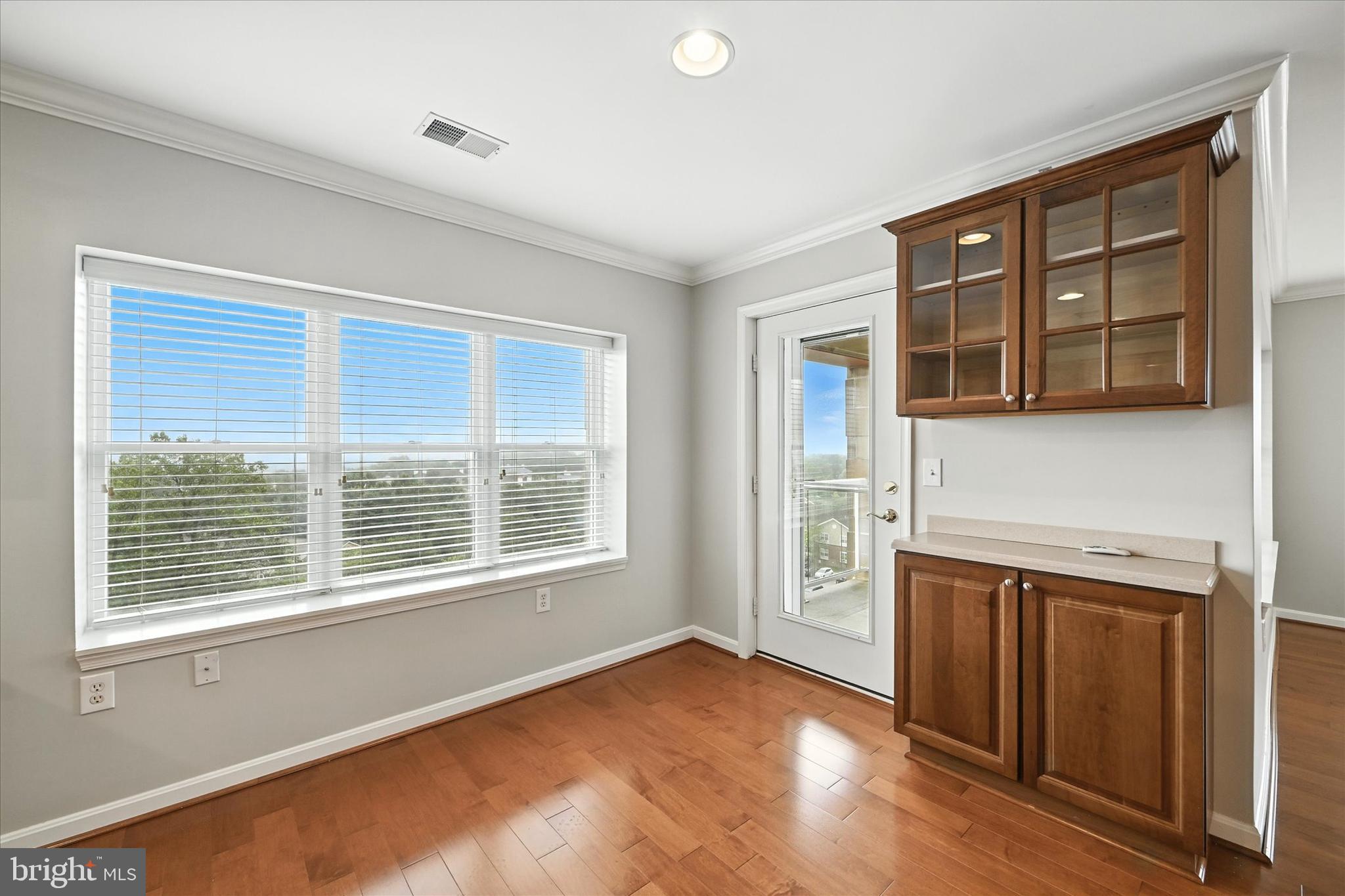 12240 Roundwood Road, Unit 808 Lutherville-Timonium, MD 21093 - Photo 15 of 31 a view of an empty room with a window and wooden floor
