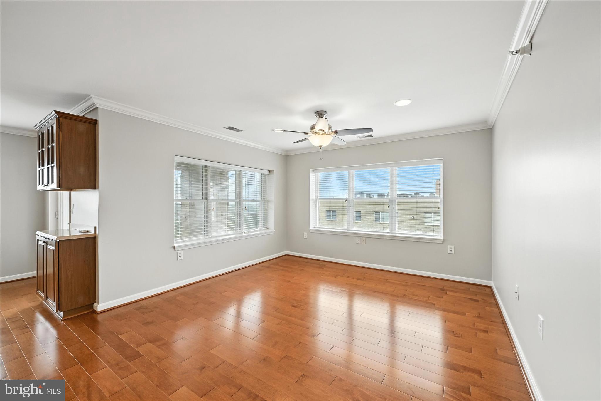 12240 Roundwood Road, Unit 808 Lutherville-Timonium, MD 21093 - Photo 17 of 31 a view of an empty room with wooden floor and a window