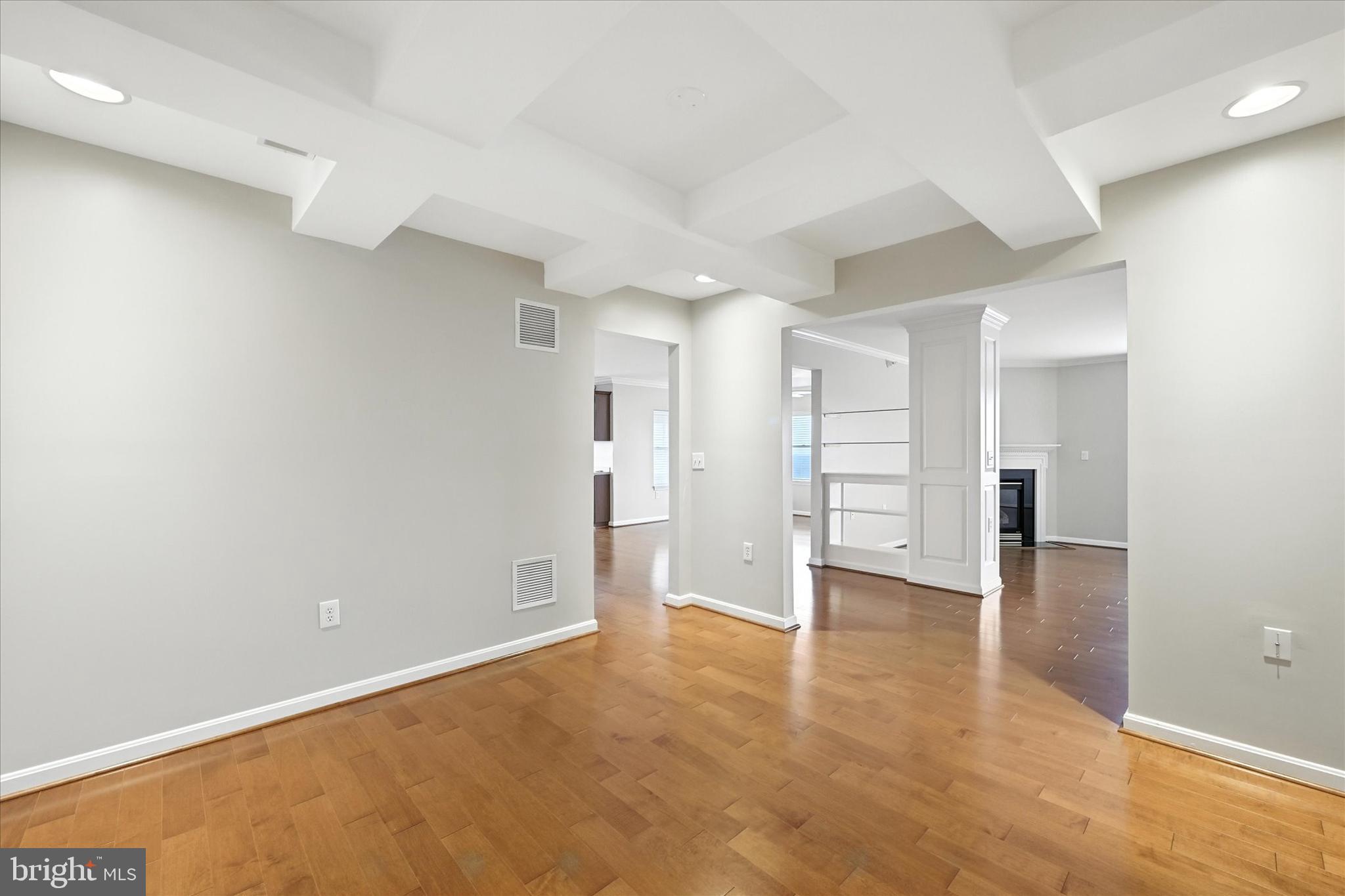 12240 Roundwood Road, Unit 808 Lutherville-Timonium, MD 21093 - Photo 20 of 31 wooden floor in an empty room with a kitchen