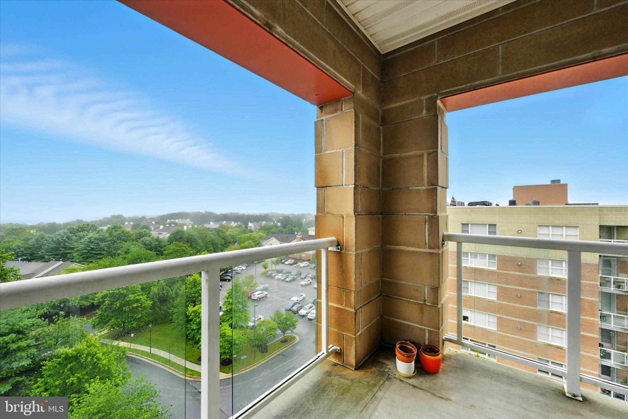 12240 Roundwood Road, Unit 808 Lutherville-Timonium, MD 21093 - Photo 29 of 31 a view of a balcony with floor to ceiling window and wooden floor