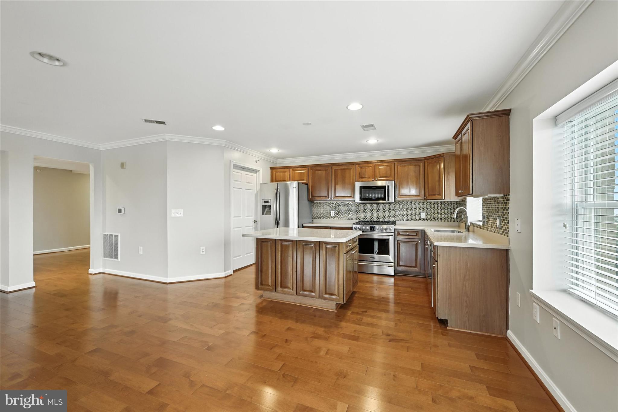 12240 Roundwood Road, Unit 808 Lutherville-Timonium, MD 21093 - Photo 9 of 31 a view of kitchen with kitchen island microwave and stove top oven