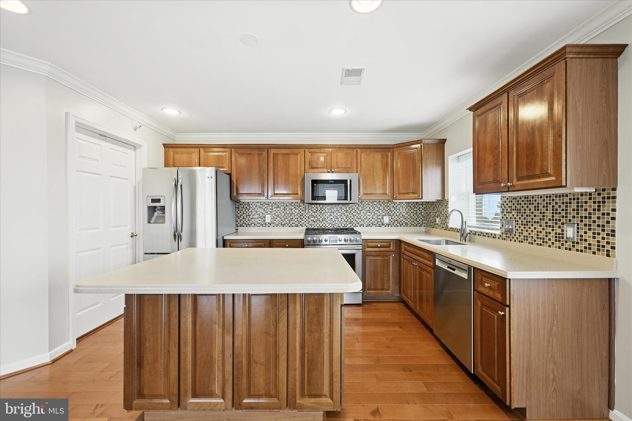 12240 Roundwood Road, Unit 808 Lutherville-Timonium, MD 21093 - Photo 10 of 31 a kitchen with stainless steel appliances granite countertop a sink stove refrigerator and cabinets
