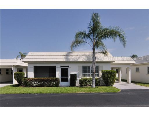 6150 Midnight Pass Road, Unit 25 Sarasota, FL 34242 - Photo 1 of 1 a front view of a house with a garden and yard
