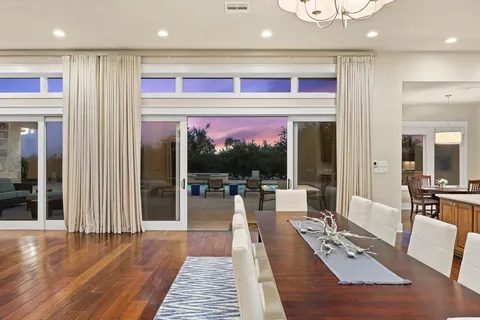a view of a dining room with furniture wooden floor and chandelier