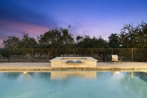 a view of a swimming pool with a yard