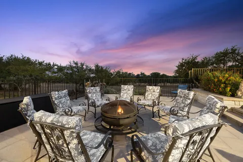a view of a lake with furniture and a fire pit