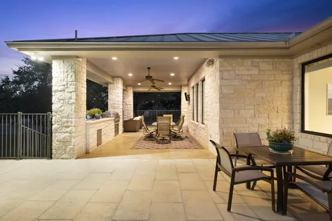 a view of a patio with table and chairs
