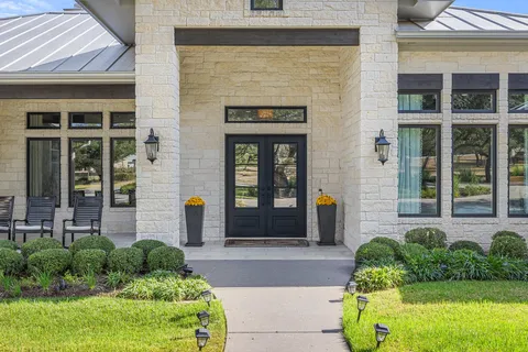a front view of a house with garden