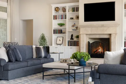 a living room with furniture fireplace and flat screen tv