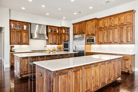 a view of a dining room and livingroom with furniture wooden floor a chandelier