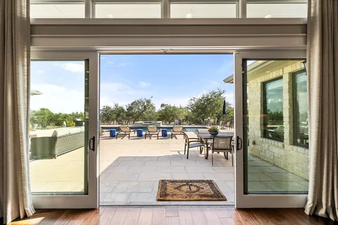 a view of a swimming pool with outdoor seating and plants