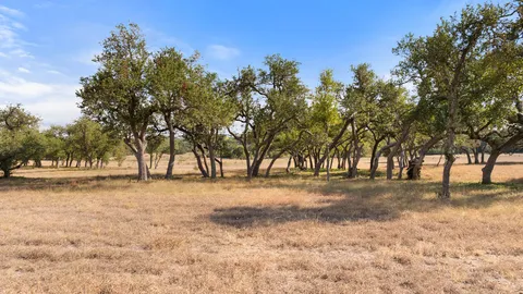 a outdoor space with the couches and dining table with the garden view
