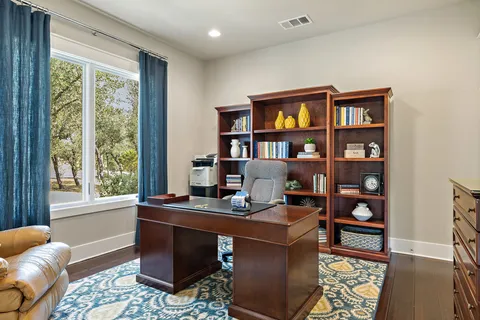 a living room with furniture and floor to ceiling windows