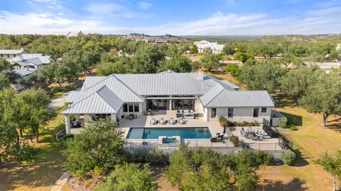 an aerial view of a house with yard swimming pool and outdoor seating
