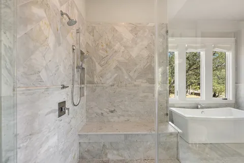 a bathroom with a bathtub and shower