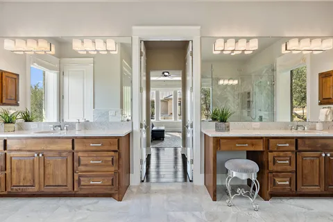 a spacious bathroom with a granite countertop sink a mirror and a