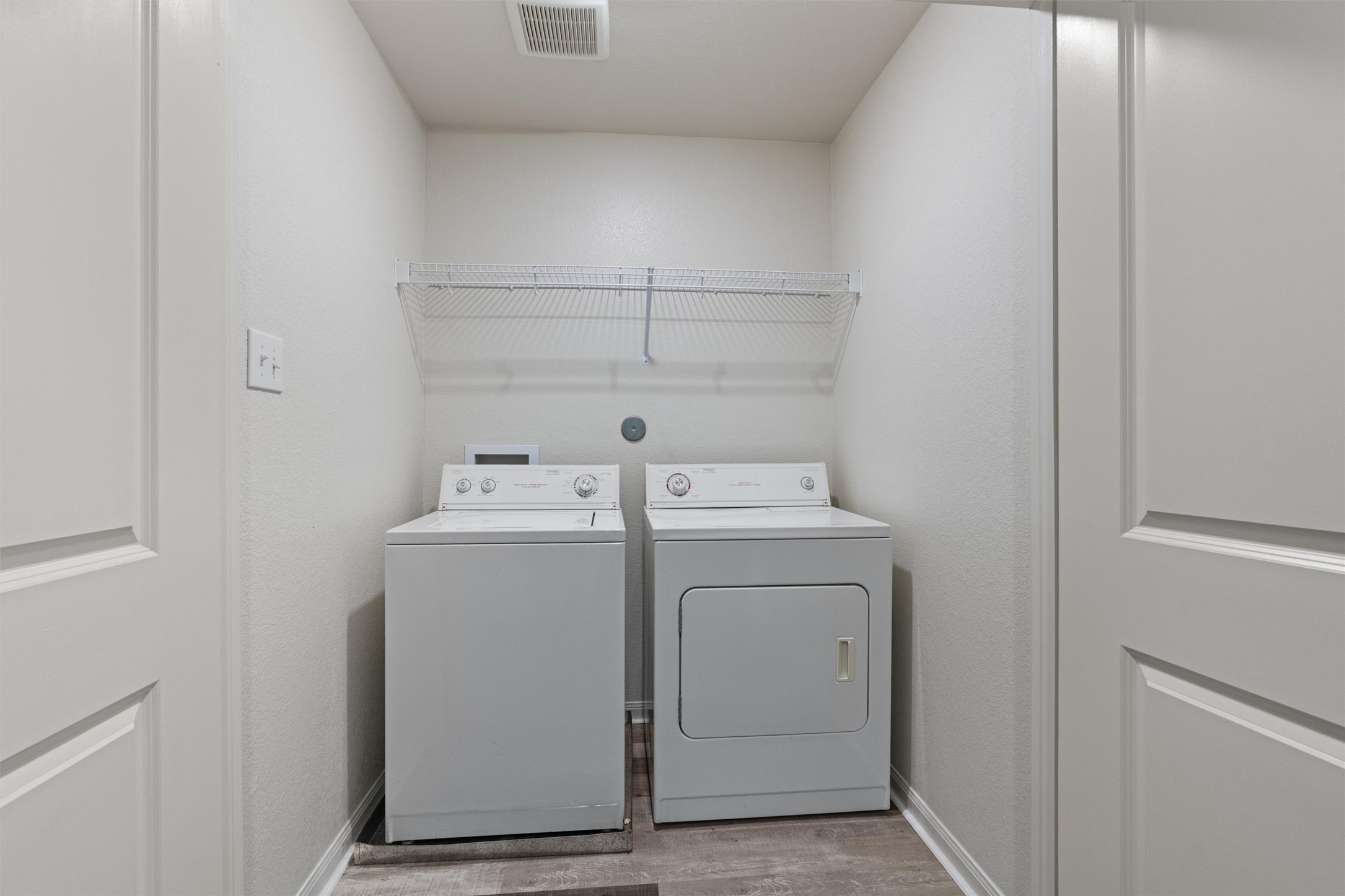 163 Niven Path, Unit 12K Jarrell, TX 76537 - Photo 27 of 31 a utility room with dryer and washer