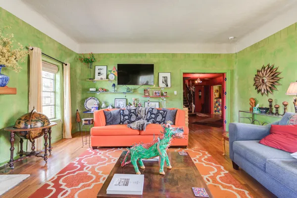 a living room with furniture a flat screen tv and a fireplace