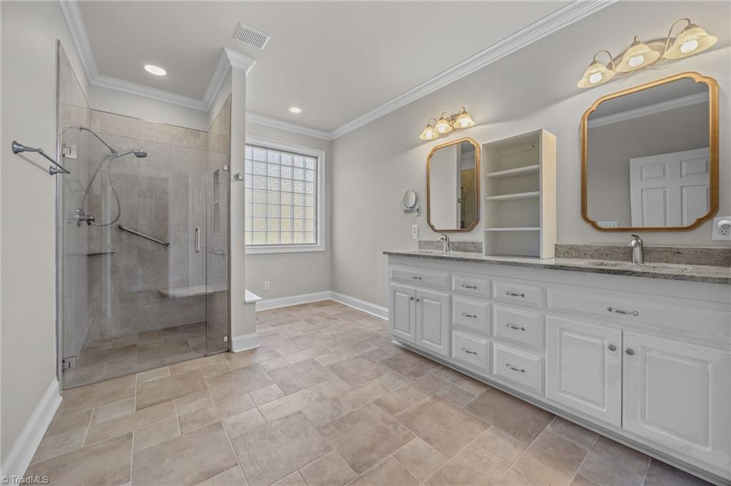 2000 Muirfield Court Elon, NC 27244 - Photo 17 of 43 Primary Suite Bath with update Zero Entrance Shower and double Vanity w/ raised Commode