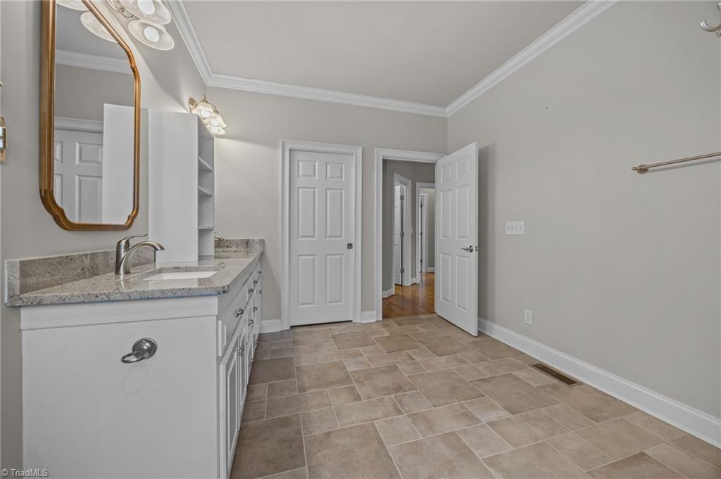 2000 Muirfield Court Elon, NC 27244 - Photo 23 of 43 Primary Bath w/ Tile Floors and double vanity ... recently updated.