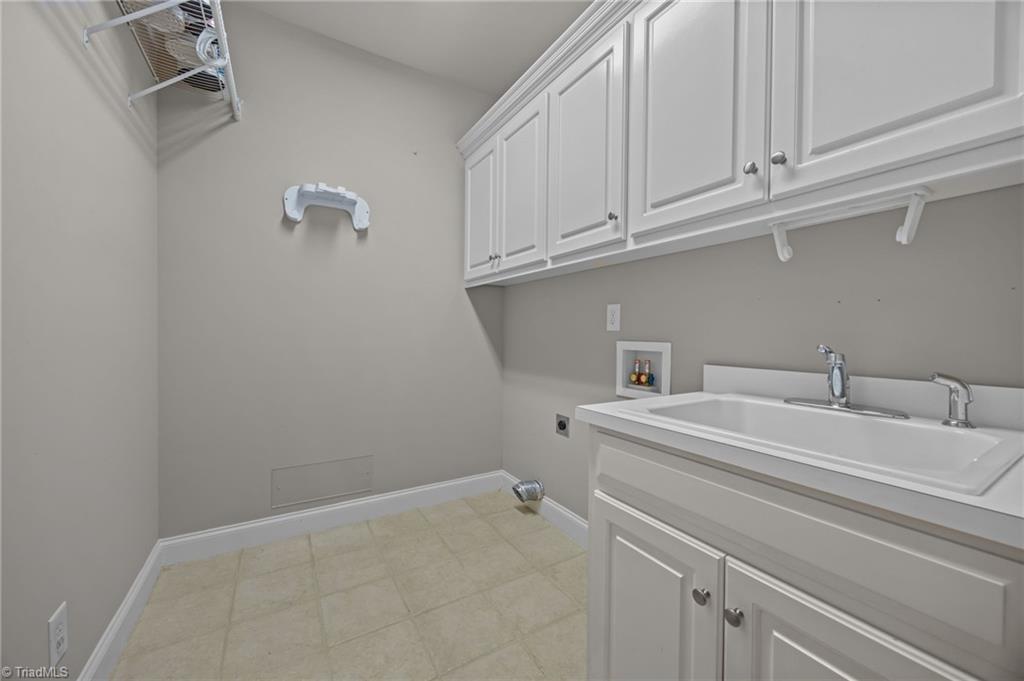 2000 Muirfield Court Elon, NC 27244 - Photo 27 of 43 Laundry Room w/ Sink & Cabinets (9x7 approx)