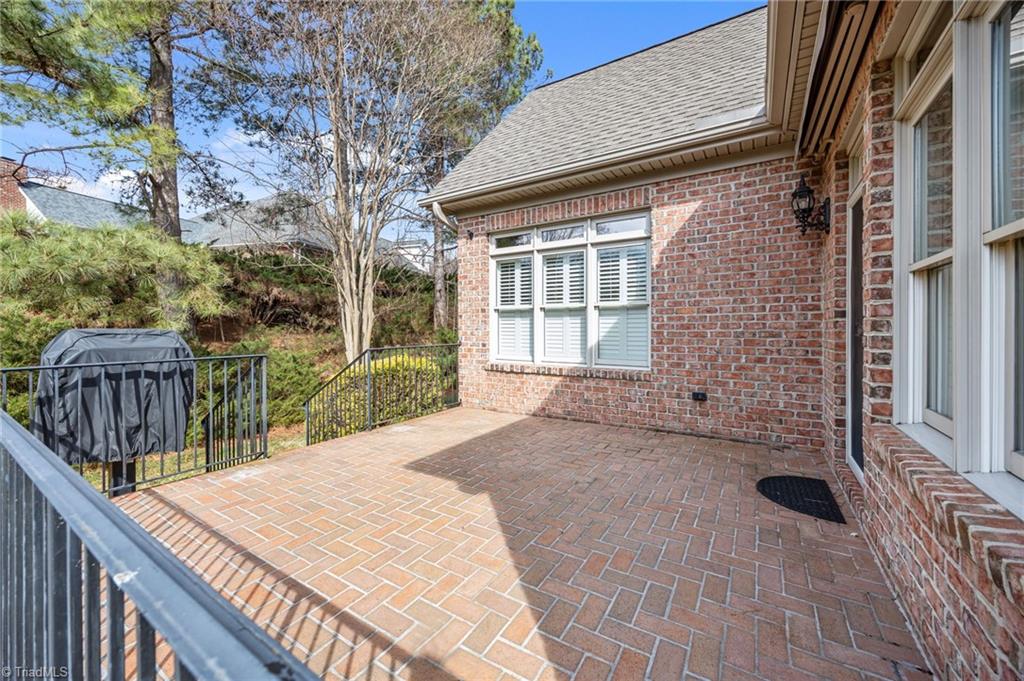 2000 Muirfield Court Elon, NC 27244 - Photo 30 of 43 Back raised Patio w/ install Gas Grill & Retractable Awning that covers the patio!