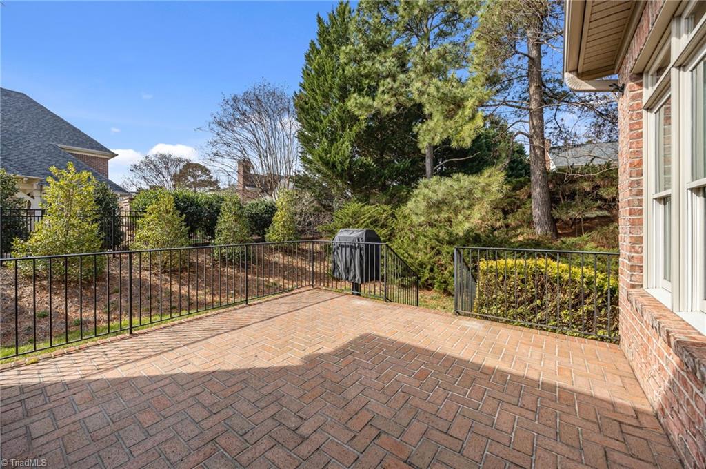 2000 Muirfield Court Elon, NC 27244 - Photo 32 of 43 Back Patio w/ railings and installed Gas Grill and Remote Controlled Awning that covers the Patio