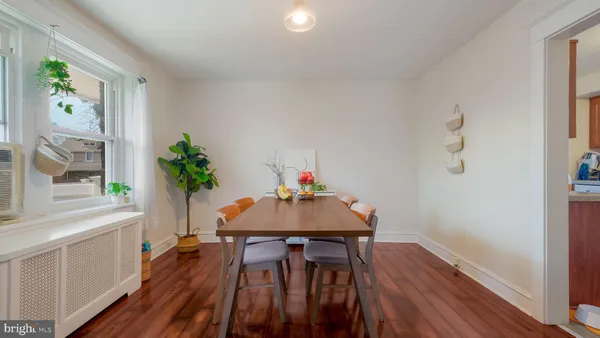 a dining room with furniture and wooden floor