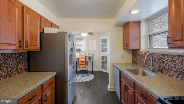 a kitchen that has a sink and a stove in it