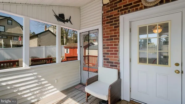 a outdoor space of a house with wooden floor and windows