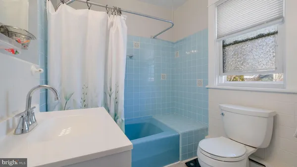 a bathroom with a sink a mirror and a bathtub