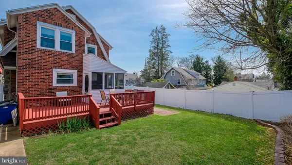 a view of a deck with table and chairs with wooden floor and fence