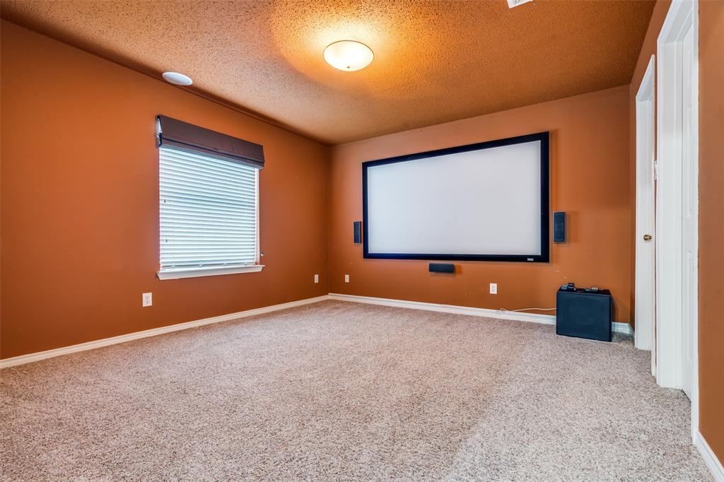 3421 Neiman Road Plano, TX 75025 - Photo 26 of 40 Carpeted cinema with a textured ceiling and baseboards