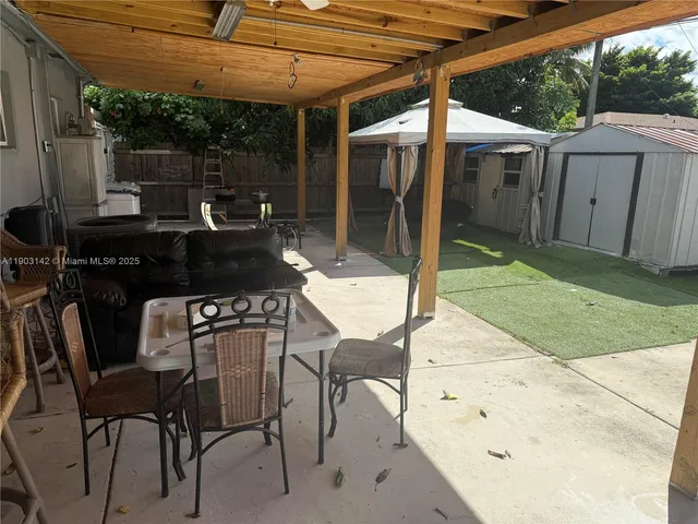 a patio with table and chairs