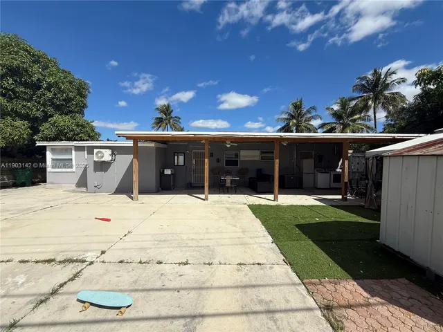 a view of a house with a yard and potted plants